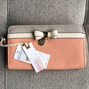 Jessica Simpson wallet. Peach and gray with ivory bow. Zipper closure.